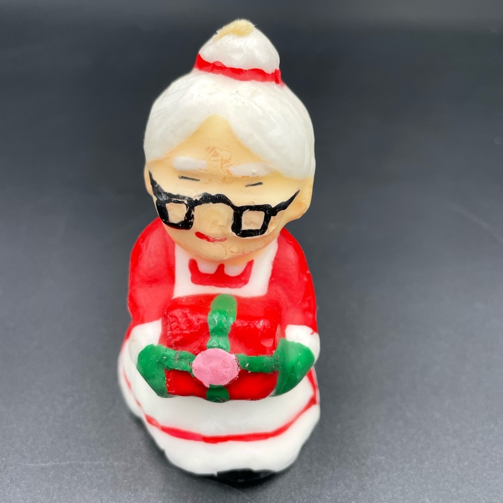 Vintage Mrs. Claus Holding A Christmas Present Candle
